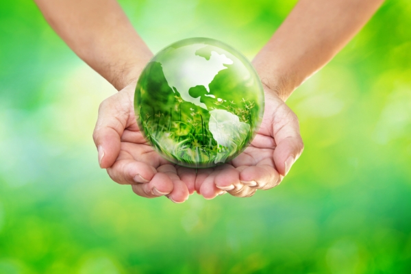 sustainability- man holding green planet in his hands